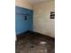 Small bedroom with stained walls, exposed electrical, and damaged flooring at 709 G St, Las Vegas, NV 89106
