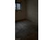Empty bedroom with a single window and bare floors, ready for a new design at 709 G St, Las Vegas, NV 89106