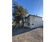 Exterior view of a two story home with rock landscaping and boarded up windows at 709 G St, Las Vegas, NV 89106