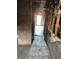 Damaged hallway featuring tile floors and visible wall studs leading to a bright doorway at 709 G St, Las Vegas, NV 89106