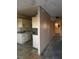View of the kitchen cabinets and a wall looking into another room with window light at 709 G St, Las Vegas, NV 89106