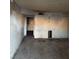 Living room with tile flooring, stained walls, and an adjacent doorway at 709 G St, Las Vegas, NV 89106