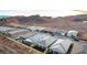 Scenic aerial view of single-Gathering homes nestled in a desert community with mountain views at 76 Tatahatso Point St, Henderson, NV 89011