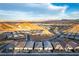 Breathtaking aerial view showcasing homes in a vibrant community against a backdrop of mountains and water at 76 Tatahatso Point St, Henderson, NV 89011