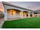 Backyard featuring a covered patio and artificial grass at 76 Tatahatso Point St, Henderson, NV 89011