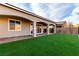 Lush backyard features a covered patio and a manicured lawn, ideal for outdoor gatherings at 76 Tatahatso Point St, Henderson, NV 89011