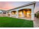 Inviting backyard featuring a covered patio, artificial grass, and stylish pavers at 76 Tatahatso Point St, Henderson, NV 89011
