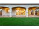Backyard featuring a covered patio, artificial grass, and stylish pavers at 76 Tatahatso Point St, Henderson, NV 89011