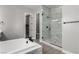 A spa-like bathroom featuring a soaking tub, frameless glass shower, and modern finishes at 76 Tatahatso Point St, Henderson, NV 89011