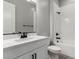 Modern bathroom features a tiled shower, white vanity, and sleek, dark fixtures at 76 Tatahatso Point St, Henderson, NV 89011