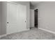 A light-filled bedroom features carpeting and double doors to a closet at 76 Tatahatso Point St, Henderson, NV 89011