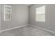 This bedroom has neutral paint, soft carpeting and ample light from the large windows at 76 Tatahatso Point St, Henderson, NV 89011