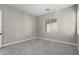 Bedroom with plush carpet, neutral paint, and a bright window with views at 76 Tatahatso Point St, Henderson, NV 89011
