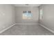Neutral bedroom with plush carpet, and large windows, offering natural light and space at 76 Tatahatso Point St, Henderson, NV 89011