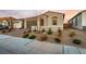 Charming single-story home with brick driveway, two-car garage, stone accents, and desert landscaping at 76 Tatahatso Point St, Henderson, NV 89011