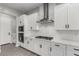 Updated kitchen boasting white cabinets, stainless steel appliances, and modern fixtures at 76 Tatahatso Point St, Henderson, NV 89011