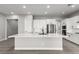 Spacious kitchen featuring a large center island with a sink, stainless appliances, and modern cabinetry at 76 Tatahatso Point St, Henderson, NV 89011