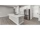Modern kitchen with stainless steel appliances, a large island, and a spacious layout at 76 Tatahatso Point St, Henderson, NV 89011