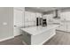 Bright kitchen with stainless steel appliances, a large island, and modern white cabinets at 76 Tatahatso Point St, Henderson, NV 89011