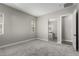 A spacious main bedroom features neutral paint, plush carpeting, and ensuite bathroom access at 76 Tatahatso Point St, Henderson, NV 89011