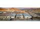 View of a neighborhood of modern homes with desert landscaping and mountain views at 76 Tatahatso Point St, Henderson, NV 89011