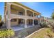 Two story home featuring a spacious covered patio and balcony with a low maintenance yard at 7641 Jacaranda Bay St, Las Vegas, NV 89139