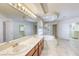 Large primary bath with dual sinks, soaking tub, walk-in shower, and walk-in closet at 7641 Jacaranda Bay St, Las Vegas, NV 89139