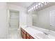 Bathroom with double sinks, vanity, and a bathtub with shower at 7641 Jacaranda Bay St, Las Vegas, NV 89139