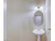 Traditional half bathroom featuring pedestal sink, silver fixtures and neutral decor at 7641 Jacaranda Bay St, Las Vegas, NV 89139