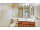 Bathroom boasts an expansive mirror, a modern vanity with storage, and a toilet at 7641 Jacaranda Bay St, Las Vegas, NV 89139