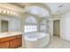 Bright bathroom showcasing a soaking tub, glass shower and custom tray ceiling at 7641 Jacaranda Bay St, Las Vegas, NV 89139
