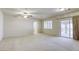 Large main bedroom featuring neutral carpeting, ceiling fan, and sliding glass doors to balcony at 7641 Jacaranda Bay St, Las Vegas, NV 89139