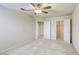 Bedroom featuring a ceiling fan, carpeted flooring, and an open walk-in closet at 7641 Jacaranda Bay St, Las Vegas, NV 89139