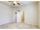 Spacious bedroom featuring a ceiling fan, neutral carpet, and an open closet for easy storage at 7641 Jacaranda Bay St, Las Vegas, NV 89139