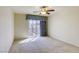 Sunlit bedroom with sliding glass doors and curtains offering a private outdoor view at 7641 Jacaranda Bay St, Las Vegas, NV 89139