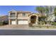 Charming two-story home with a three-car garage, terracotta roof, manicured landscaping, and a paver driveway at 7641 Jacaranda Bay St, Las Vegas, NV 89139