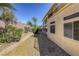 Side yard with low maintenance landscaping and two story home with balconies at 7641 Jacaranda Bay St, Las Vegas, NV 89139