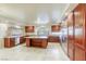 Spacious kitchen features custom cabinets, a large kitchen island, and stainless steel appliances at 7641 Jacaranda Bay St, Las Vegas, NV 89139