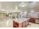 Large kitchen island with a microwave and open shelving is the centerpiece of this spacious kitchen at 7641 Jacaranda Bay St, Las Vegas, NV 89139
