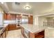 Bright kitchen featuring a large kitchen island with stainless steel microwave and custom cabinets at 7641 Jacaranda Bay St, Las Vegas, NV 89139