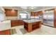 Well-lit kitchen with custom cabinets, a large kitchen island, and stainless steel appliances at 7641 Jacaranda Bay St, Las Vegas, NV 89139
