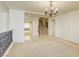 Open living room features neutral carpet, decorative chandelier, and staircase access at 7641 Jacaranda Bay St, Las Vegas, NV 89139