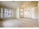 Bright living room featuring large windows, high ceilings, and neutral paint tones at 7641 Jacaranda Bay St, Las Vegas, NV 89139