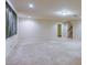 Bright living room features neutral carpeting, recessed lighting, and access to the stairway at 7641 Jacaranda Bay St, Las Vegas, NV 89139