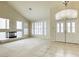 Elegant living room with a fireplace, large windows, and a soaring ceiling at 7641 Jacaranda Bay St, Las Vegas, NV 89139