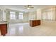An expansive living room features tile flooring, three bright windows, and a convenient sink and counter area at 7641 Jacaranda Bay St, Las Vegas, NV 89139