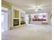 Open-concept living room with fireplace that flows into a nearby, bright kitchen at 7641 Jacaranda Bay St, Las Vegas, NV 89139