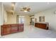 Spacious living area with tiled floors, ceiling fan, wet bar and sliding glass door to the backyard at 7641 Jacaranda Bay St, Las Vegas, NV 89139