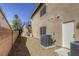 View of the side yard featuring low maintenance landscaping and exterior access door at 7641 Jacaranda Bay St, Las Vegas, NV 89139