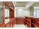 Wet bar with sink, cabinets, wine rack, and open shelving with lots of storage at 7641 Jacaranda Bay St, Las Vegas, NV 89139